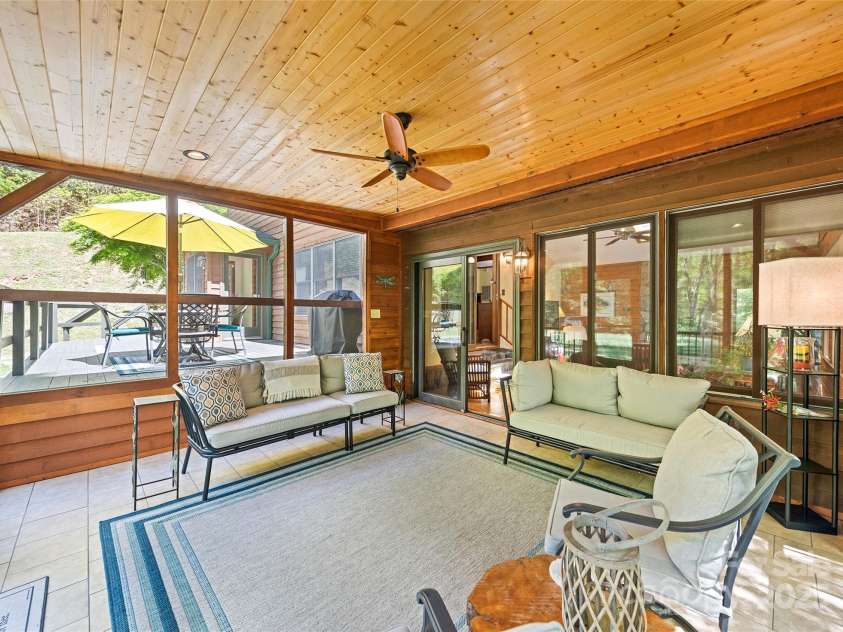 1192 Rockdale Road, Whittier, NC 28789.  MLS# CAR4239563, YatesRealty ID 12259. Den opens to the screened in porch