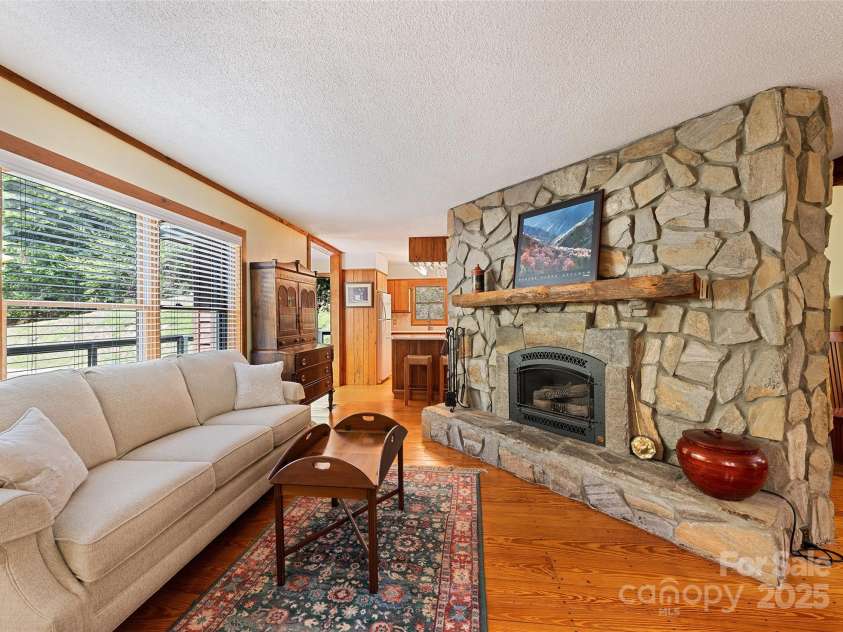 1192 Rockdale Road, Whittier, NC 28789.  MLS# CAR4239563, YatesRealty ID 12259. Rock fireplace is the focal point