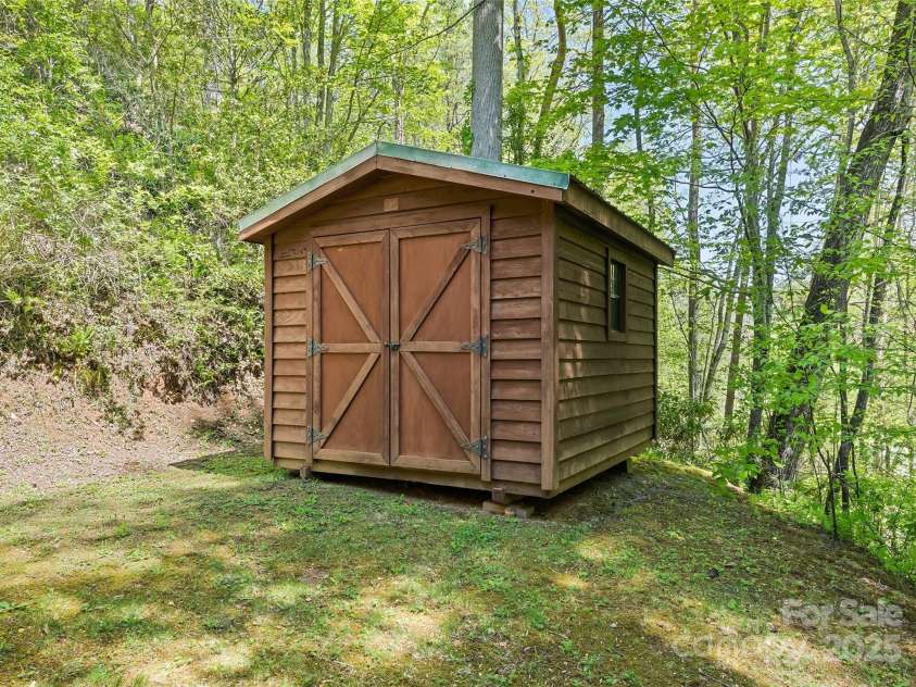 1192 Rockdale Road, Whittier, NC 28789.  MLS# CAR4239563, YatesRealty ID 12259. Storage shed behind garage