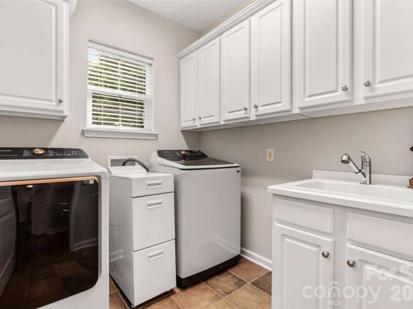 9332 Whistling Straits Drive, Fort Mill, SC 29707.  MLS# CAR4332758, YatesRealty ID 12280. Separate laundry room with mud sink and storage closets