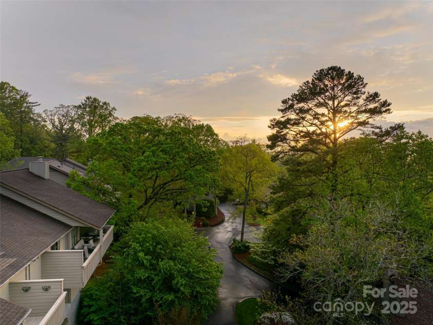 1901 Timber Trail, Asheville, NC 28804.  MLS# CAR4252207, YatesRealty ID 12288. Covered Deck is surrounded by mature trees, lush landscaping and beautiful sunsets.