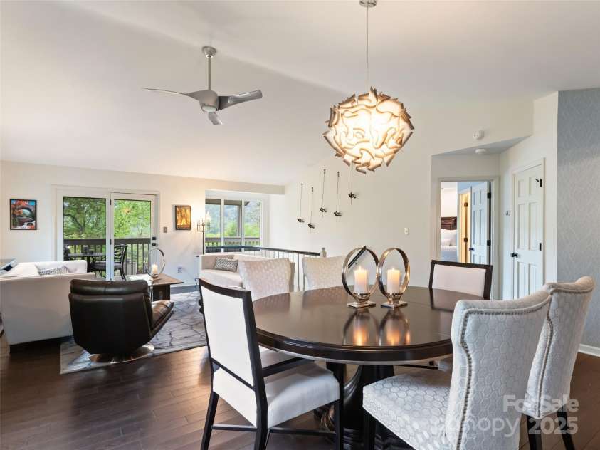 1901 Timber Trail, Asheville, NC 28804.  MLS# CAR4252207, YatesRealty ID 12288. Open dining area joins seamlessly with living area that overlooks the large covered deck surrounded by mature trees and long range mountain views.