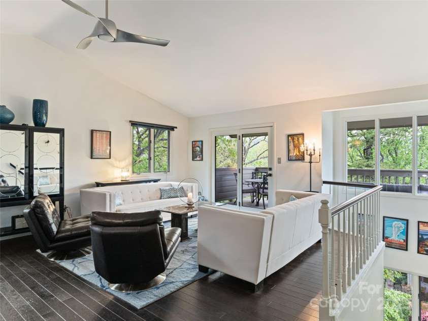 1901 Timber Trail, Asheville, NC 28804.  MLS# CAR4252207, YatesRealty ID 12288. Open Great Room/ vaulted ceiling filled with natural light, wood floors, walls of windows; sliding doors to covered deck. Allows for seamless indoor/outdoor entertaining.  Like living in your own sophisticated tree house