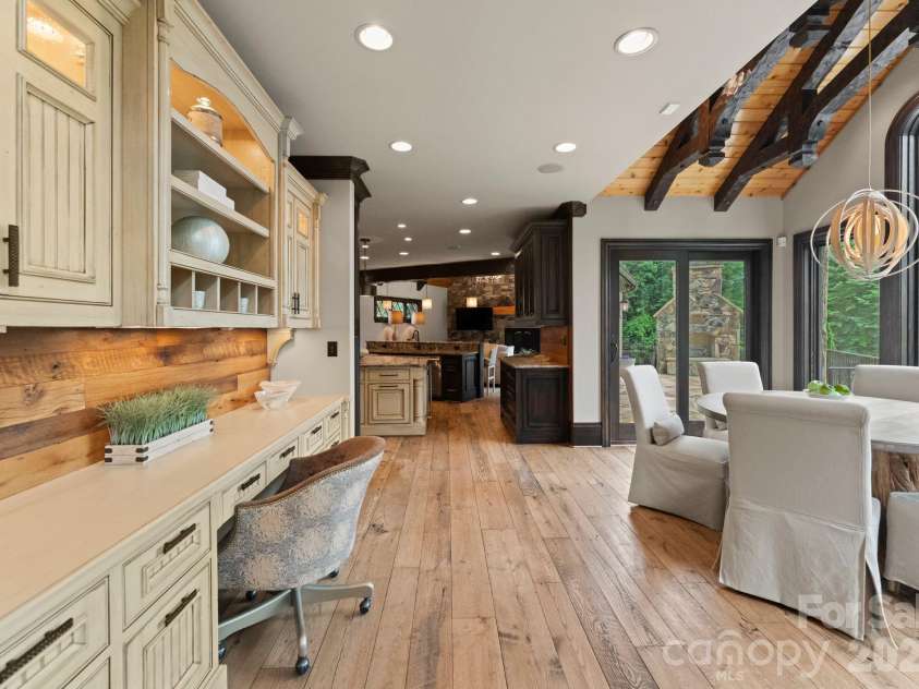 172 Tennessee Circle, Mooresville, NC 28117.  MLS# CAR4252701, YatesRealty ID 1230. Desk area between the kitchen and living room featuring custom cabinetry. 