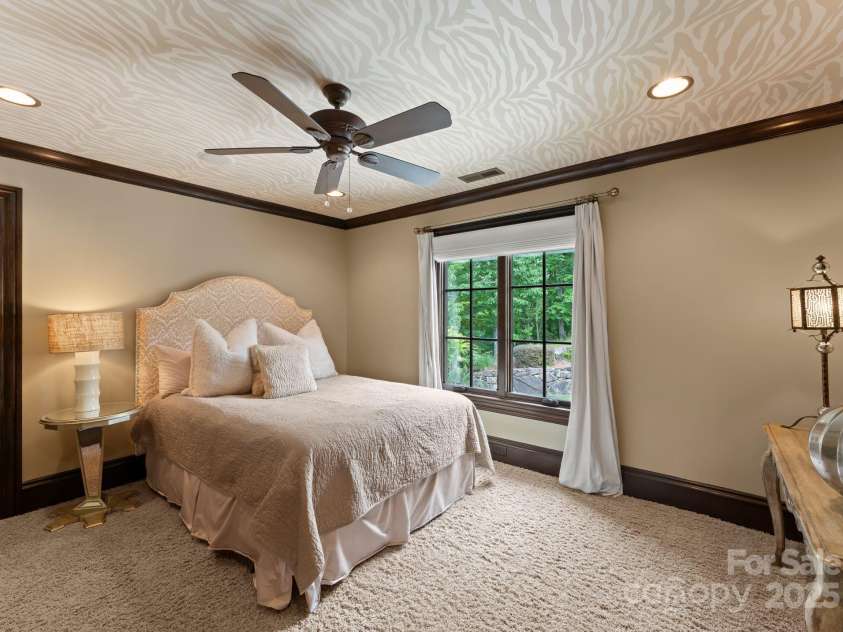 172 Tennessee Circle, Mooresville, NC 28117.  MLS# CAR4252701, YatesRealty ID 1230. Each Guest Bedroomfeatures TVs, fans, and wallpaper.