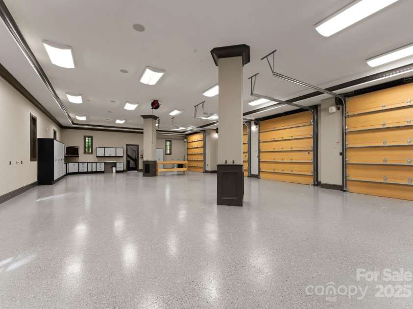 172 Tennessee Circle, Mooresville, NC 28117.  MLS# CAR4252701, YatesRealty ID 1230. Four-car Garage located within the carriage house. Includes extensive cabinetry. 