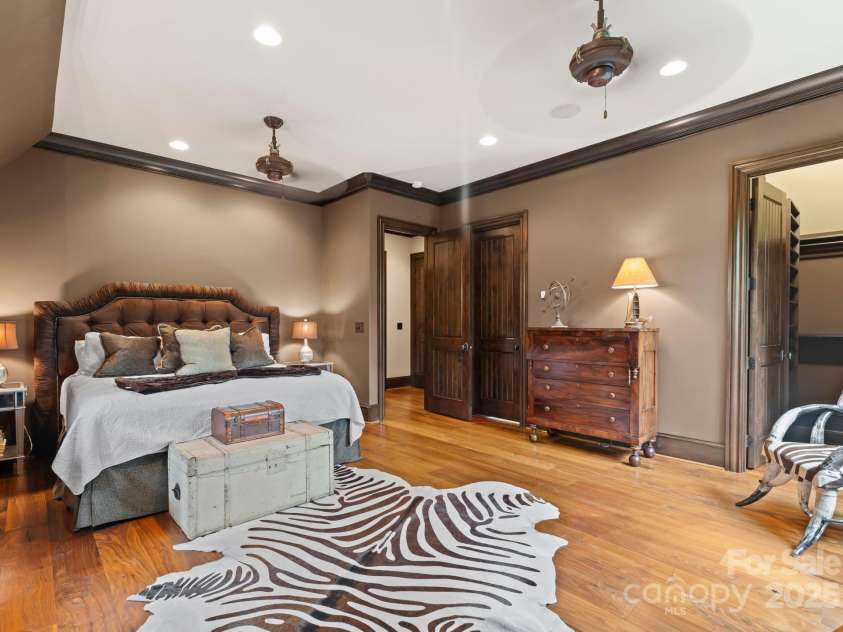 172 Tennessee Circle, Mooresville, NC 28117.  MLS# CAR4252701, YatesRealty ID 1230. Guest Apartment Bedroom is a bright and comfortable space with a seating nook and walk-in closet. The Ensuite Bathroom features a tylish walk-in shower with built-in bench and sleek finishes.