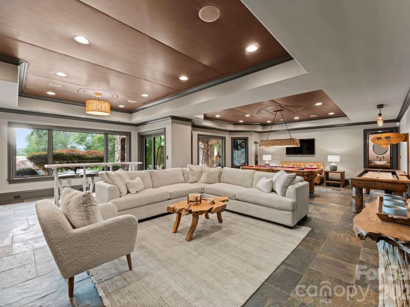 172 Tennessee Circle, Mooresville, NC 28117.  MLS# CAR4252701, YatesRealty ID 1230. Lower-Level Living Roomis an open lounge space with TVs, billiards, and arcade games.