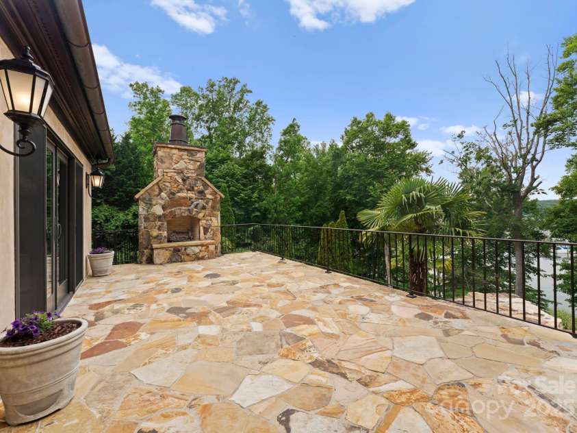 172 Tennessee Circle, Mooresville, NC 28117.  MLS# CAR4252701, YatesRealty ID 1230. Main-Level Patio featuring a fireplace and stairs connecting to lower patio and yard.