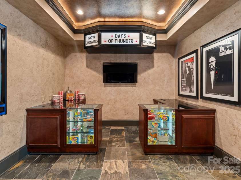172 Tennessee Circle, Mooresville, NC 28117.  MLS# CAR4252701, YatesRealty ID 1230. Vintage-style theater room entryway featuring snack cabinets and an icemaker.