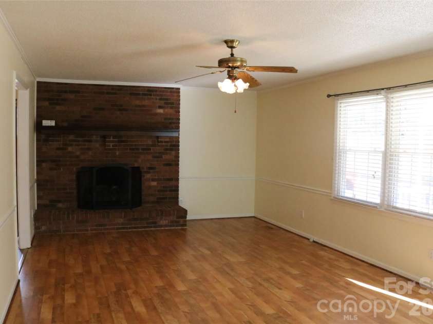 120 Oakley Drive, Gastonia, NC 28052.  MLS# CAR4317380, YatesRealty ID 12318. Living room fireplace with gas logs - great for staying warm on cool nights 