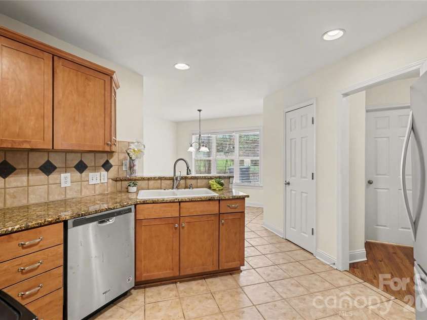 437 Hillcrest Drive, Harrisburg, NC 28075.  MLS# CAR4360523, YatesRealty ID 12320. Kitchen has granite counters, stainless steel appliances.