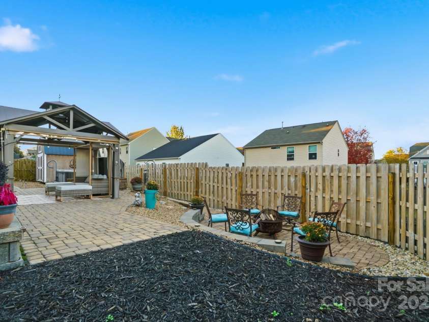 167 Gage Drive, Mooresville, NC 28115.  MLS# CAR4314236, YatesRealty ID 12324. Well-designed private backyard includes professionally installed pavers, hot tub, storage building, hard top gazebo w/sun screens, fire pit and outdoor furniture all convey with an acceptable offer!