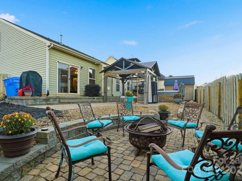 167 Gage Drive, Mooresville, NC 28115.  MLS# CAR4314236, YatesRealty ID 12324. Well-designed private backyard includes professionally installed pavers, hot tub, storage building, hard top gazebo w/sun screens, fire pit and outdoor furniture all convey with an acceptable offer!