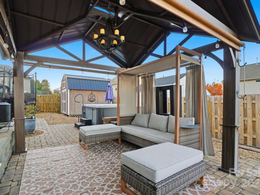 167 Gage Drive, Mooresville, NC 28115.  MLS# CAR4314236, YatesRealty ID 12324. Well-designed private backyard includes professionally installed pavers, hot tub, storage building, hard top gazebo w/sun screens, fire pit and outdoor furniture all convey with an acceptable offer!