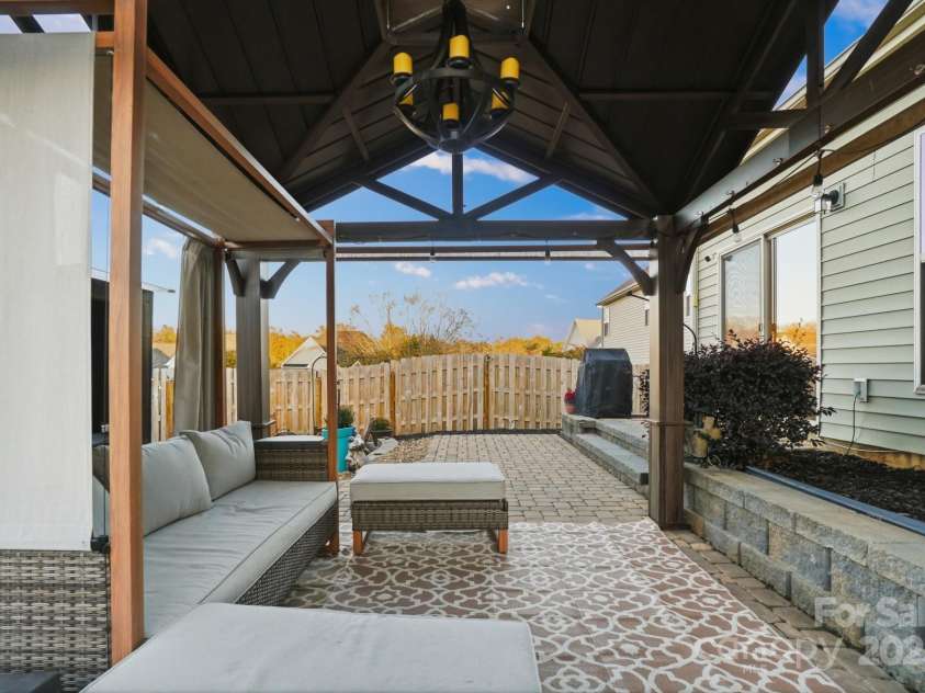 167 Gage Drive, Mooresville, NC 28115.  MLS# CAR4314236, YatesRealty ID 12324. Well-designed private backyard includes professionally installed pavers, hot tub, storage building, hard top gazebo w/sun screens, fire pit and outdoor furniture all convey with an acceptable offer!