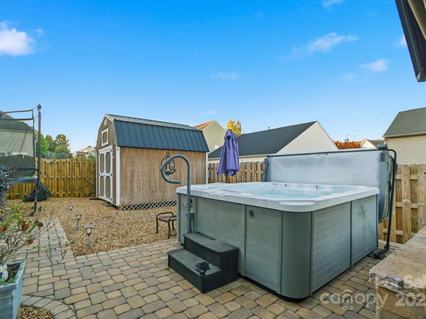 167 Gage Drive, Mooresville, NC 28115.  MLS# CAR4314236, YatesRealty ID 12324. Well-designed private backyard includes professionally installed pavers, hot tub, storage building, hard top gazebo w/sun screens, fire pit and outdoor furniture all convey with an acceptable offer!