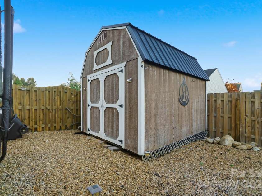 167 Gage Drive, Mooresville, NC 28115.  MLS# CAR4314236, YatesRealty ID 12324. Well-designed private backyard includes professionally installed pavers, hot tub, storage building, hard top gazebo w/sun screens, fire pit and outdoor furniture all convey with an acceptable offer!