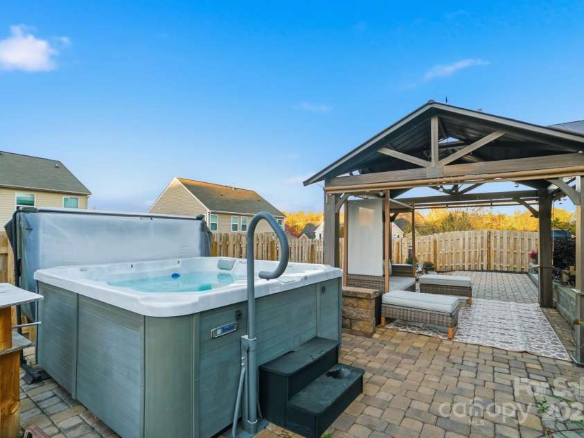 167 Gage Drive, Mooresville, NC 28115.  MLS# CAR4314236, YatesRealty ID 12324. Well-designed private backyard includes professionally installed pavers, hot tub, storage building, hard top gazebo w/sun screens, fire pit and outdoor furniture all convey with an acceptable offer!
