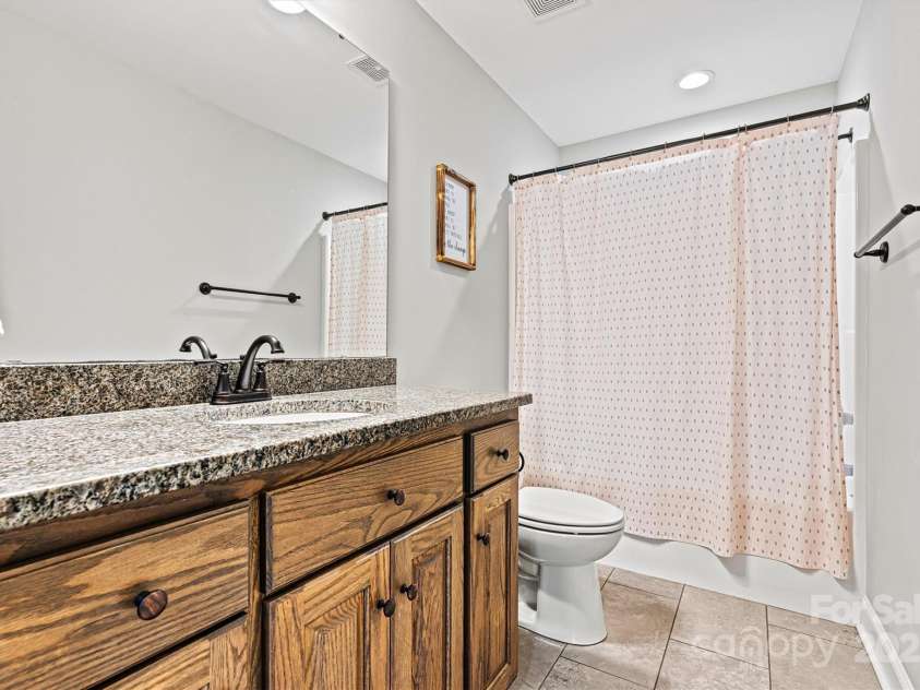 3615 Kimber Lane, Sherrills Ford, NC 28673.  MLS# CAR4250194, YatesRealty ID 12326. The hall bath has a large granite countertop and ceramic tile flooring!