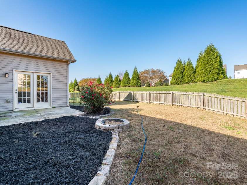 1691 Mill Creek Lane, Concord, NC 28025.  MLS# CAR4192669, YatesRealty ID 12329. Backyard Patio & Firepit