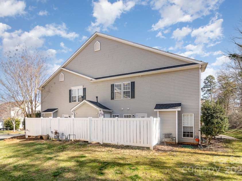9562 Littleleaf Drive, Charlotte, NC 28215.  MLS# CAR4230637, YatesRealty ID 12341. Side view of condo and fenced patio.