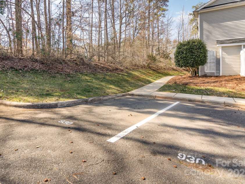 9562 Littleleaf Drive, Charlotte, NC 28215.  MLS# CAR4230637, YatesRealty ID 12341. Two designated parking spots near the walkway.