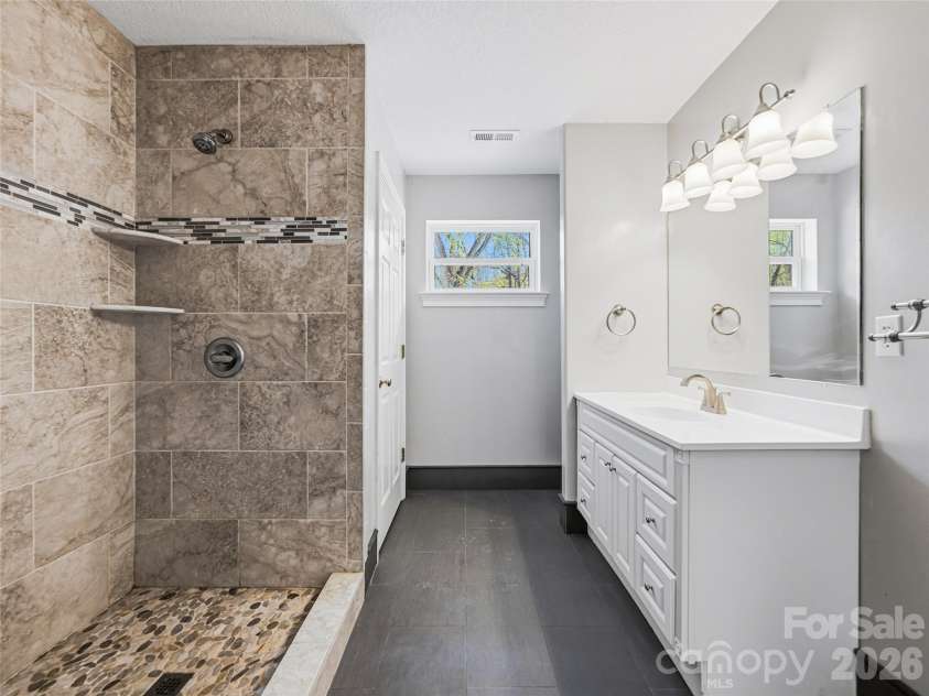 196 Blackbird Lane, Tryon, NC 28782.  MLS# CAR4366022, YatesRealty ID 12349. Upper Level Full Bathroom with Tiled Shower
