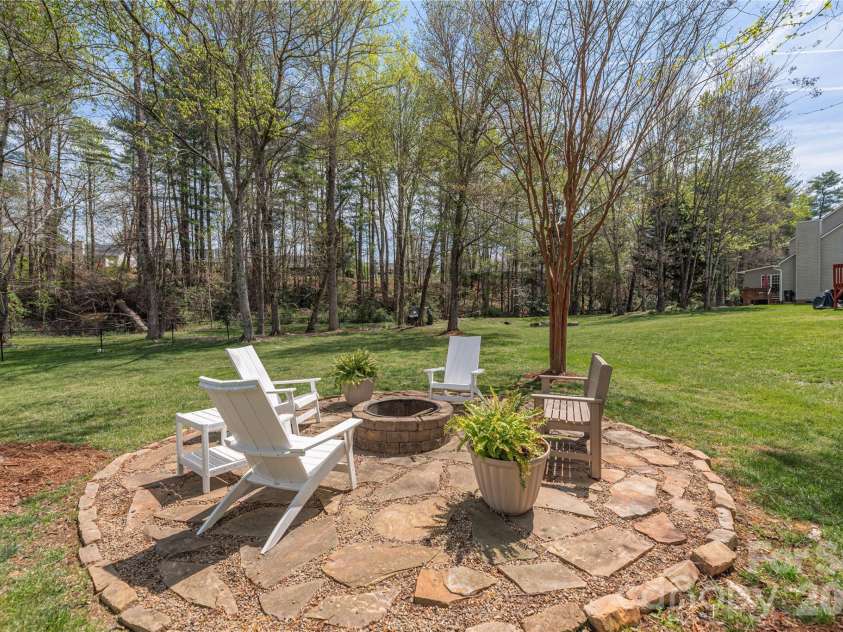 42 Cranberry Bog Court, Fletcher, NC 28732.  MLS# CAR4367619, YatesRealty ID 12351. Back yard fire pit.
