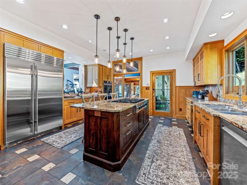 10 Beaverbrook Court, Asheville, NC 28804.  MLS# CAR4246277, YatesRealty ID 1236. Kitchen has direct access to the herb and vegetable garden via a covered back porch with sky lights.