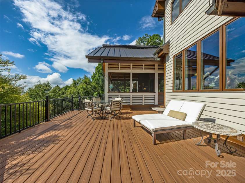 10 Beaverbrook Court, Asheville, NC 28804.  MLS# CAR4246277, YatesRealty ID 1236. Large deck adjacent to screen porich overlooking the Koi Ponds and waterfalls