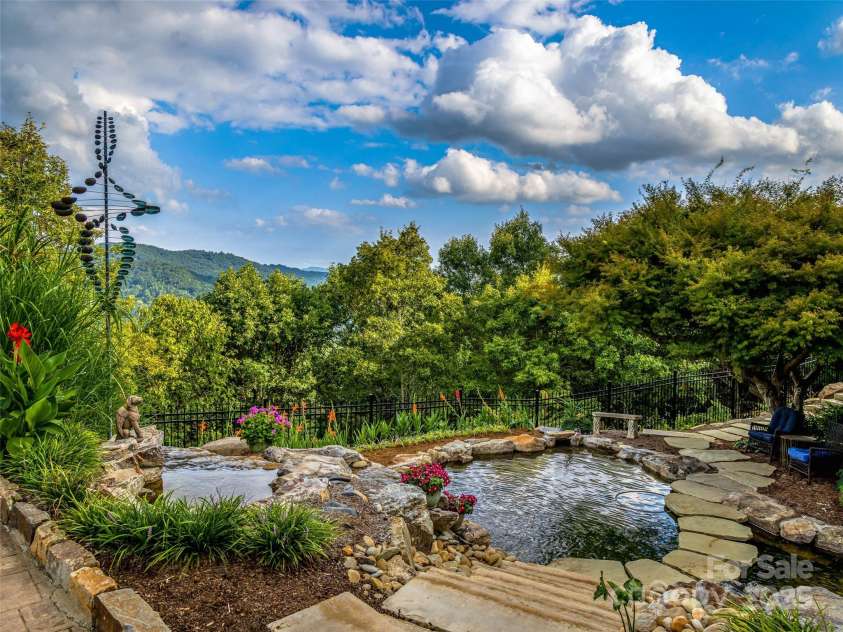 10 Beaverbrook Court, Asheville, NC 28804.  MLS# CAR4246277, YatesRealty ID 1236. Peaceful Koi pond is lit and has four waterfalls and floating steps.
