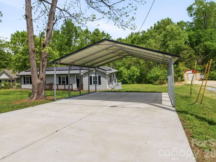 219 Breezewood Drive, Charlotte, NC 28262.  MLS# CAR4346086, YatesRealty ID 12375. Carport with EV charging