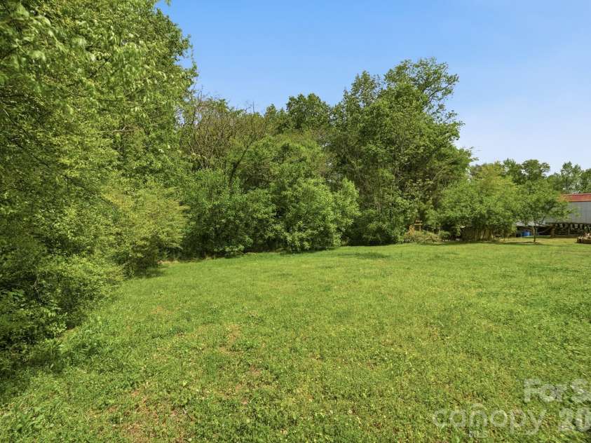 219 Breezewood Drive, Charlotte, NC 28262.  MLS# CAR4346086, YatesRealty ID 12375. Wood back property 
