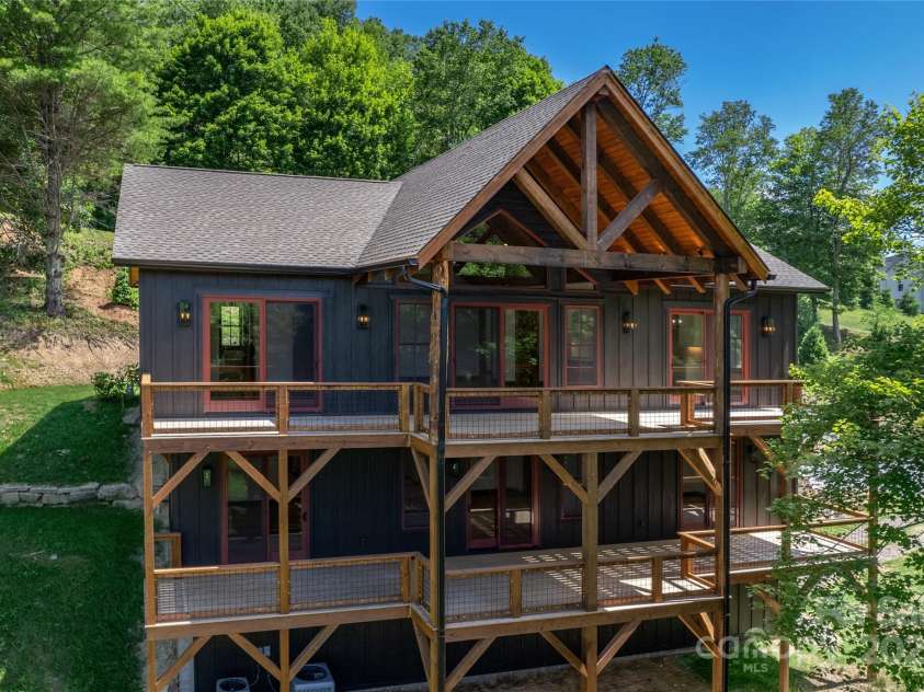 750 Silver Springs Drive, Banner Elk, NC 28604.  MLS# CAR4160928, YatesRealty ID 1238. 3,178 HLA with 4 bedrooms, 4 full bathrooms, 3 car garage with amble storage, over 1,200 square feet of outdoor space including main level porte-cochere & covered porch with majestic, private mountain & pond views