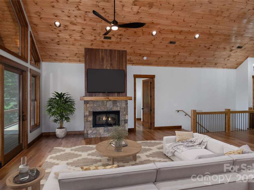 750 Silver Springs Drive, Banner Elk, NC 28604.  MLS# CAR4160928, YatesRealty ID 1238. Vaulted living room with floor to ceiling sliding doors & windows and gas fireplace