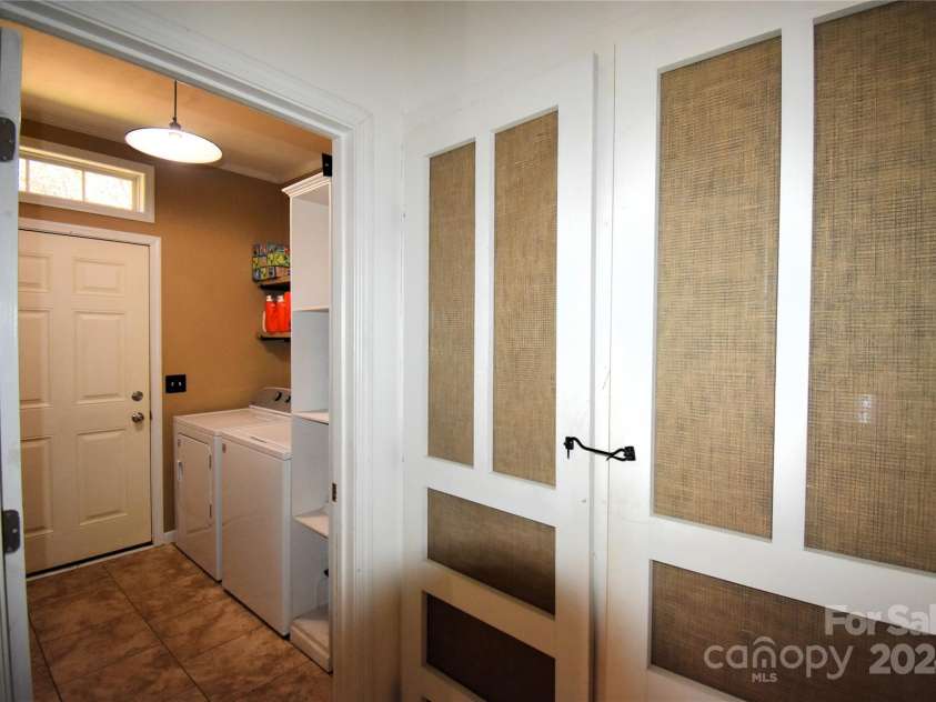 549 Freeman Creek Road, Zirconia, NC 28790.  MLS# CAR4203056, YatesRealty ID 12382. Laundry room and storage