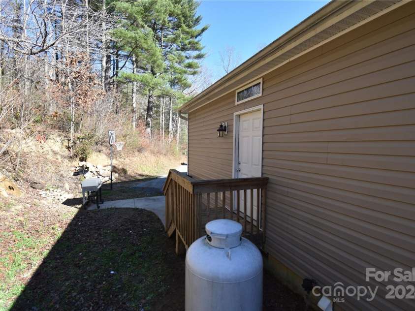 549 Freeman Creek Road, Zirconia, NC 28790.  MLS# CAR4203056, YatesRealty ID 12382. Porch to laundry room