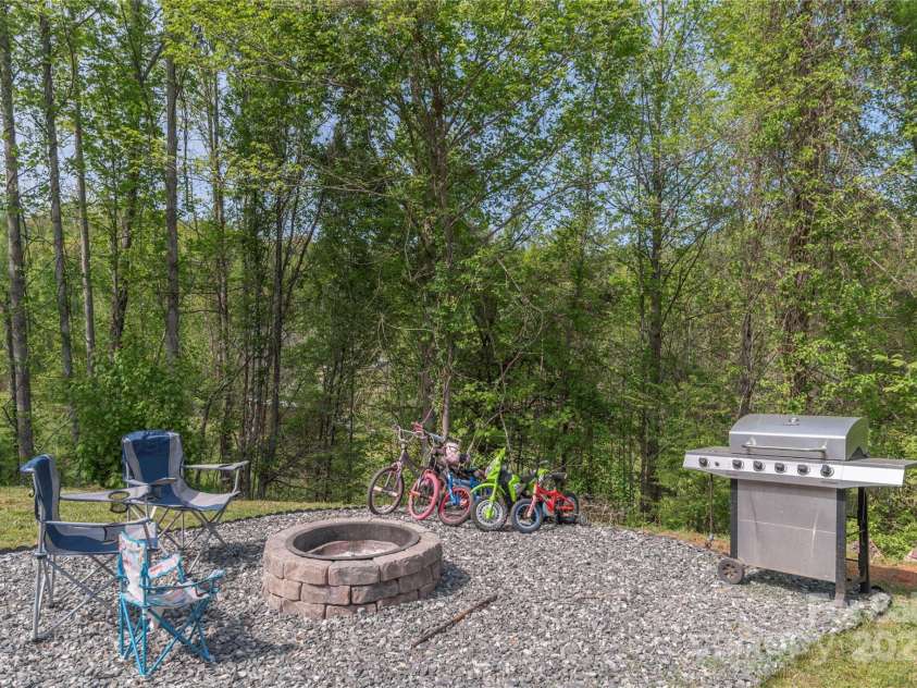 87 Horseback Lane, Marshall, NC 28753.  MLS# CAR4251023, YatesRealty ID 12384. Cozy fire pit and grilling area.