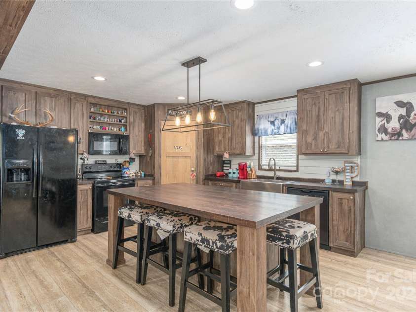 87 Horseback Lane, Marshall, NC 28753.  MLS# CAR4251023, YatesRealty ID 12384. Lots of prep space in the kitchen or extra seating with the large kitchen island.  Large pantry in the corner.  All appliances remain.