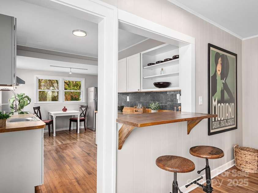 60 Fulton Street, Asheville, NC 28801.  MLS# CAR4196168, YatesRealty ID 12392. Breakfast bar opens into fully renovated kitchen.