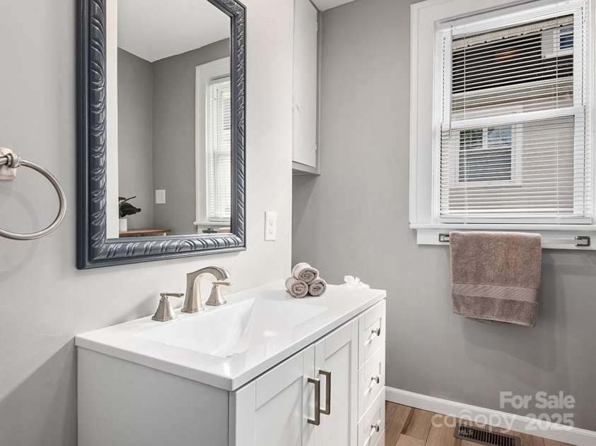 60 Fulton Street, Asheville, NC 28801.  MLS# CAR4196168, YatesRealty ID 12392. Renovated full bathroom adjacent to front bedroom. Features all new fixtures and finishes.
