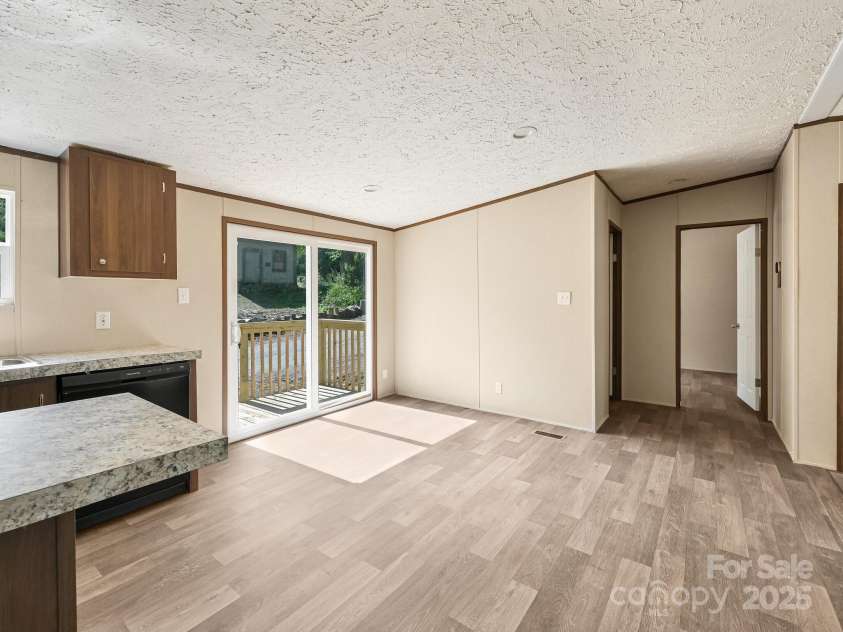 20 Windy Mountain Lane, Hendersonville, NC 28792.  MLS# CAR4204889, YatesRealty ID 12410. Standing in kitchen, facing sliding glass door and bedrooms