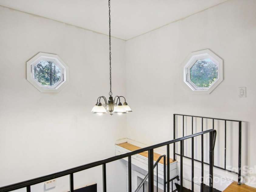 105 Big Bear Drive, Pisgah Forest, NC 28768.  MLS# CAR4192035, YatesRealty ID 12415. Top of staircase on landing outside of 2 upstairs bedrooms