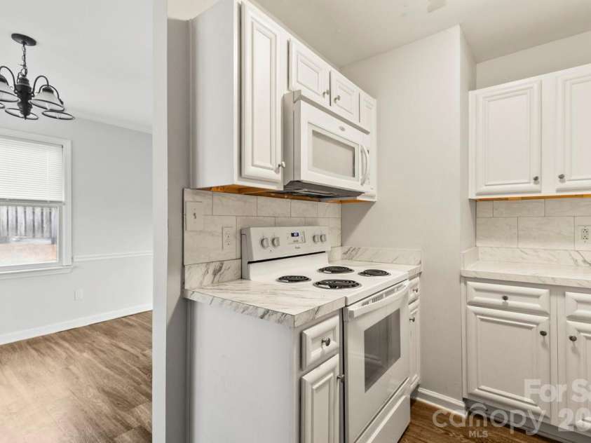 6041 Crape Myrtle Lane, Charlotte, NC 28216.  MLS# CAR4354736, YatesRealty ID 12425. White appliances including stove and microwave 