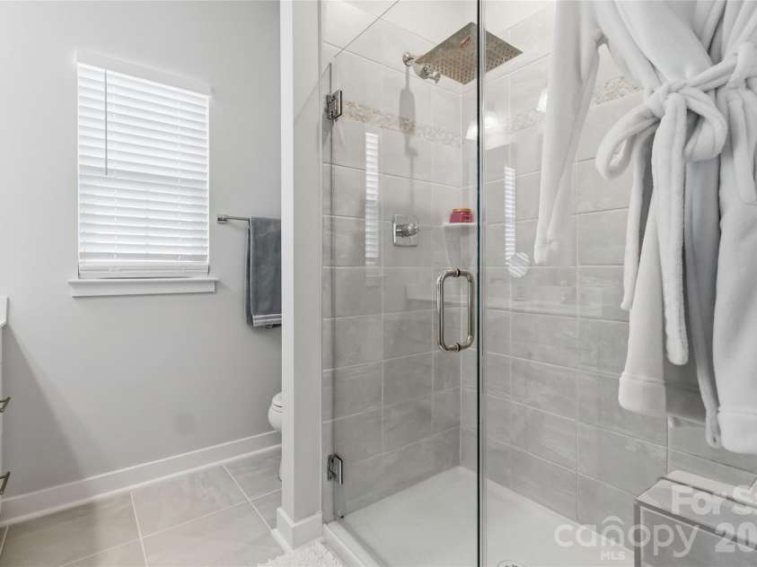 3149 Beeler Lane, Charlotte, NC 28208.  MLS# CAR4352531, YatesRealty ID 12426. Framless shower in primary bathroom