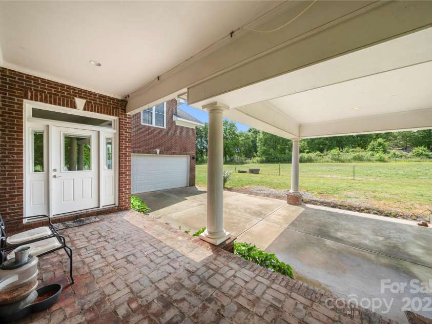 6218 Indian Trail Fairview Road, Indian Trail, NC 28079.  MLS# CAR4327618, YatesRealty ID 12442. Port cochere style carport and wrap around porches 