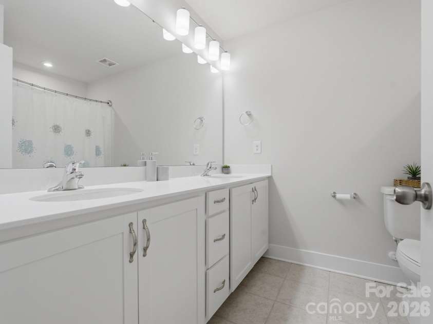3309 Treble Court, Charlotte, NC 28262.  MLS# CAR4355630, YatesRealty ID 12451. Guest bathroom w/ dual sinks