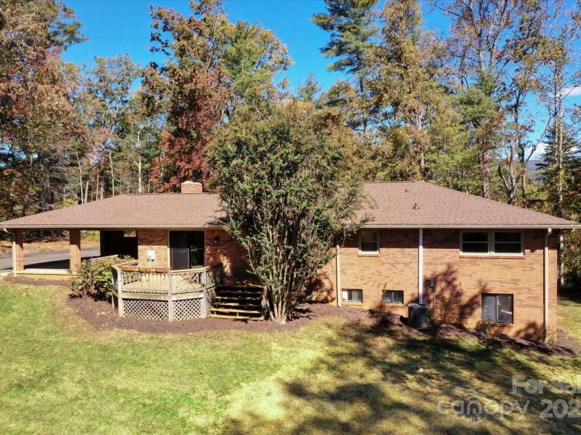 90 Joe Jenkins Road, Fairview, NC 28730.  MLS# CAR4288516, YatesRealty ID 12466. An expansive outdoor space that is well-suited for various recreational and lifestyle preferences. The yard is large enough to potentially accommodate a swimming pool, a flourishing garden, and offers ample room for pet
