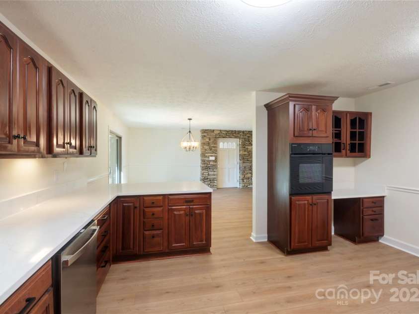 90 Joe Jenkins Road, Fairview, NC 28730.  MLS# CAR4288516, YatesRealty ID 12466. Take a look at the stunning cabinets in this home. We've also installed beautiful new quartz countertops and brand-new, energy-efficient appliances to complete this kitchen remodel.